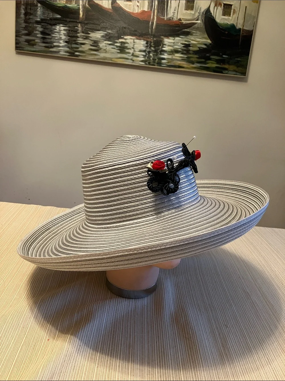 Wide Brim Straw Hat with Black Decorative Knot and Red Floral Accent